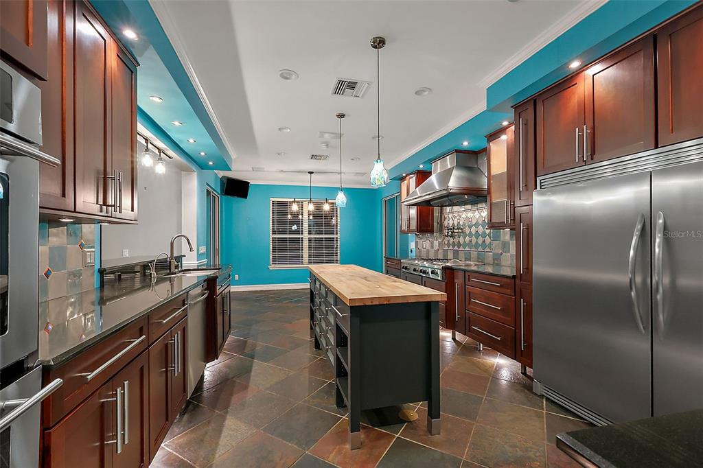 28004 Shirley Shores Road Tavares, FL 32778 - Photo 20 of 68 a kitchen with stainless steel appliances granite countertop a sink a stove and a refrigerator