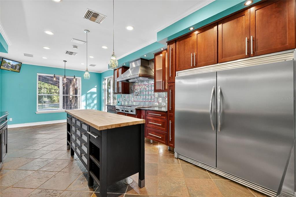 28004 Shirley Shores Road Tavares, FL 32778 - Photo 22 of 68 a kitchen with kitchen island a counter top space a sink stainless steel appliances and cabinets