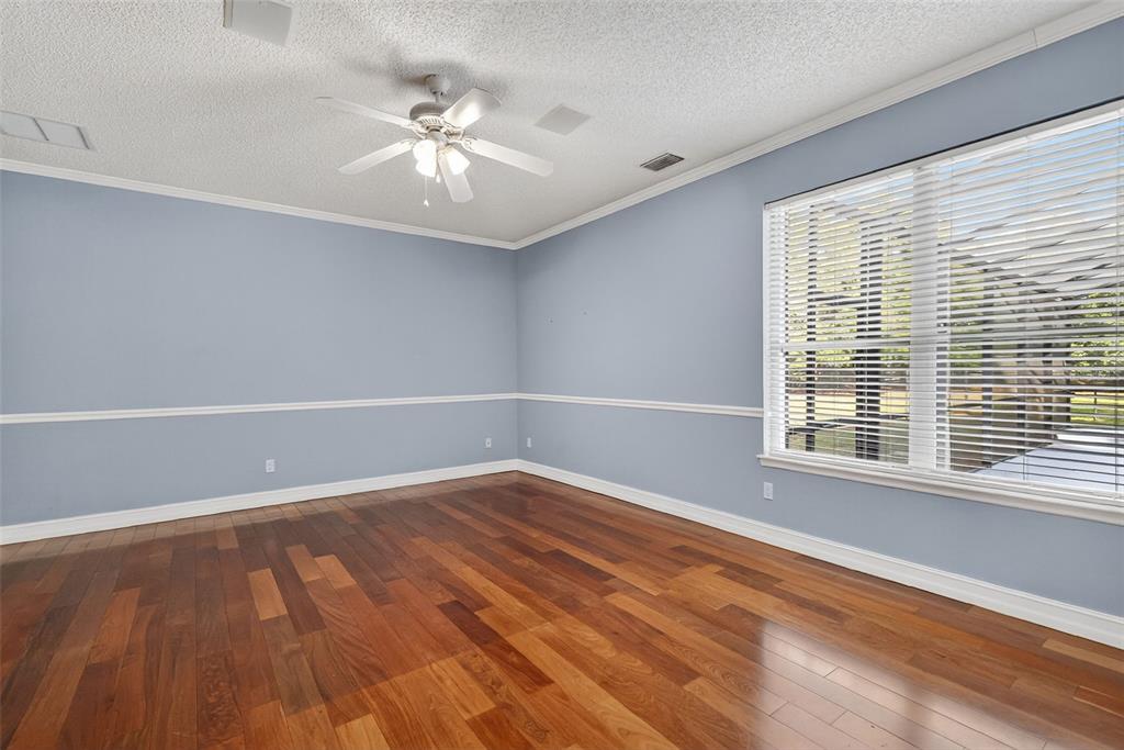 28004 Shirley Shores Road Tavares, FL 32778 - Photo 29 of 68 a view of an empty room with wooden floor and a window
