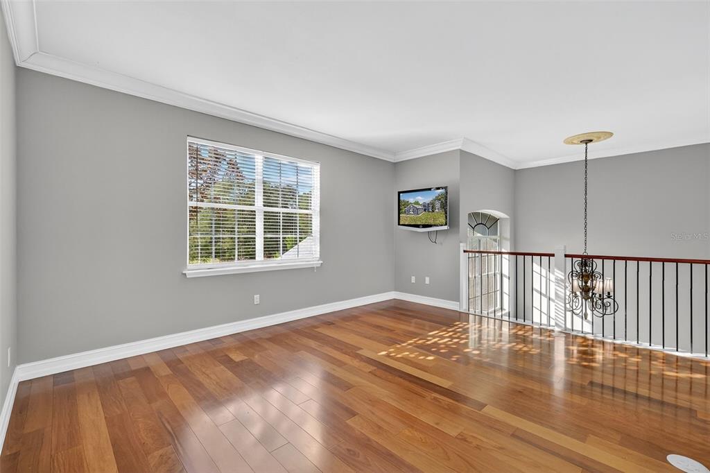 28004 Shirley Shores Road Tavares, FL 32778 - Photo 39 of 68 a view of empty room with wooden floor and fan