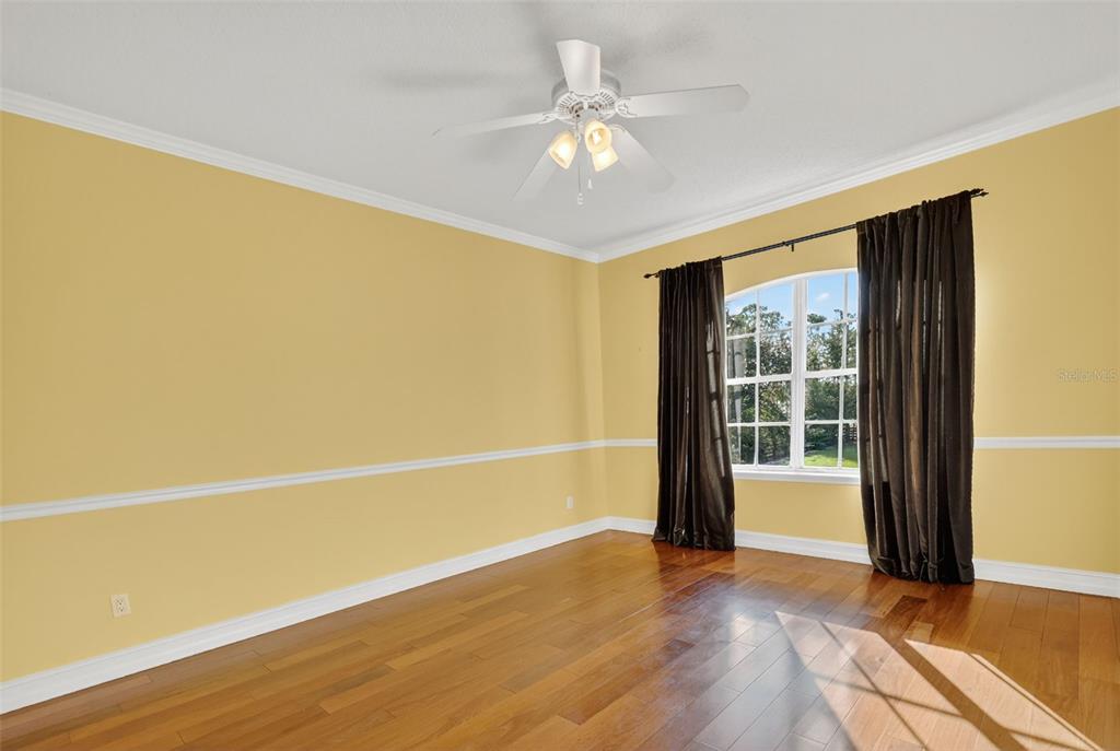28004 Shirley Shores Road Tavares, FL 32778 - Photo 41 of 68 a view of an empty room with wooden floor and a window