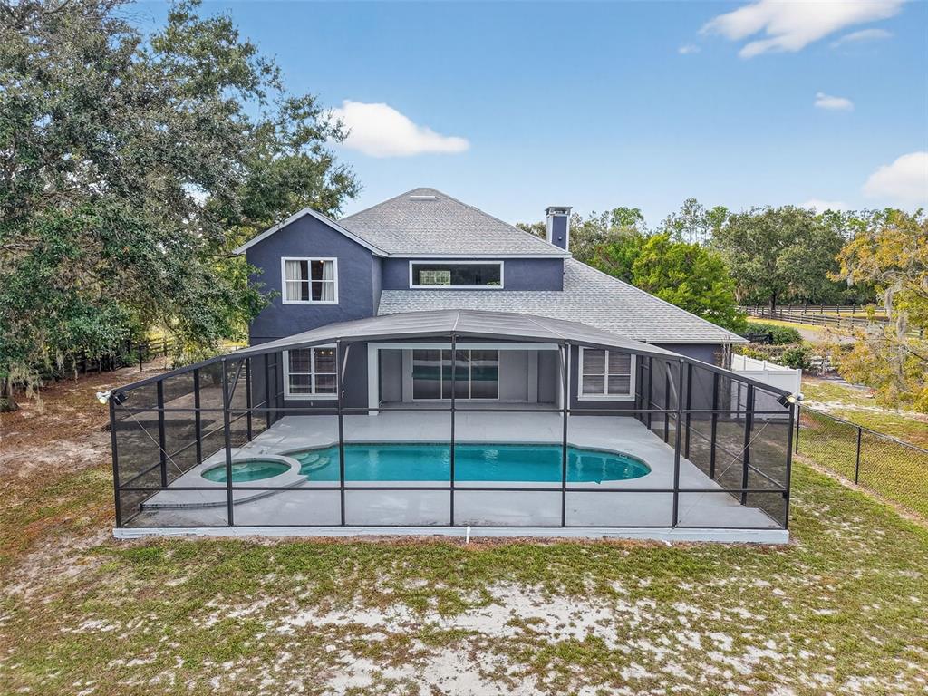 28004 Shirley Shores Road Tavares, FL 32778 - Photo 56 of 68 a view of a house with a wooden deck and a yard