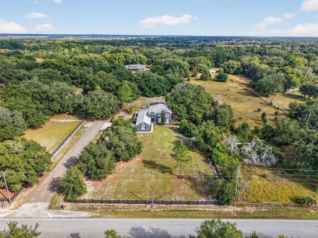 28004 Shirley Shores Road Tavares, FL 32778 - Photo 63 of 68 an aerial view of residential houses with outdoor space and trees