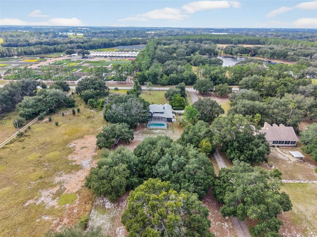 28004 Shirley Shores Road Tavares, FL 32778 - Photo 66 of 68 an aerial view of green landscape with trees houses and mountain view