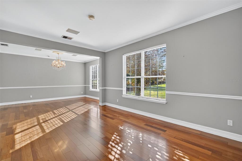 28004 Shirley Shores Road Tavares, FL 32778 - Photo 9 of 68 a view of an empty room with wooden floor and a window