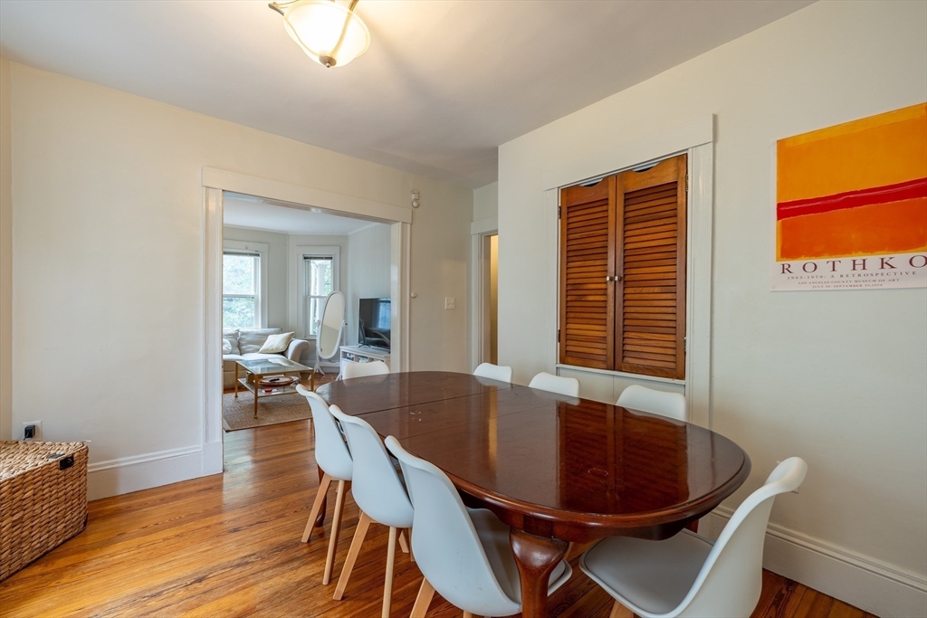 65 Allston Street, Unit 2 Cambridge, MA 02139 - Photo 4 of 11 a dining room with furniture wooden floor and a rug