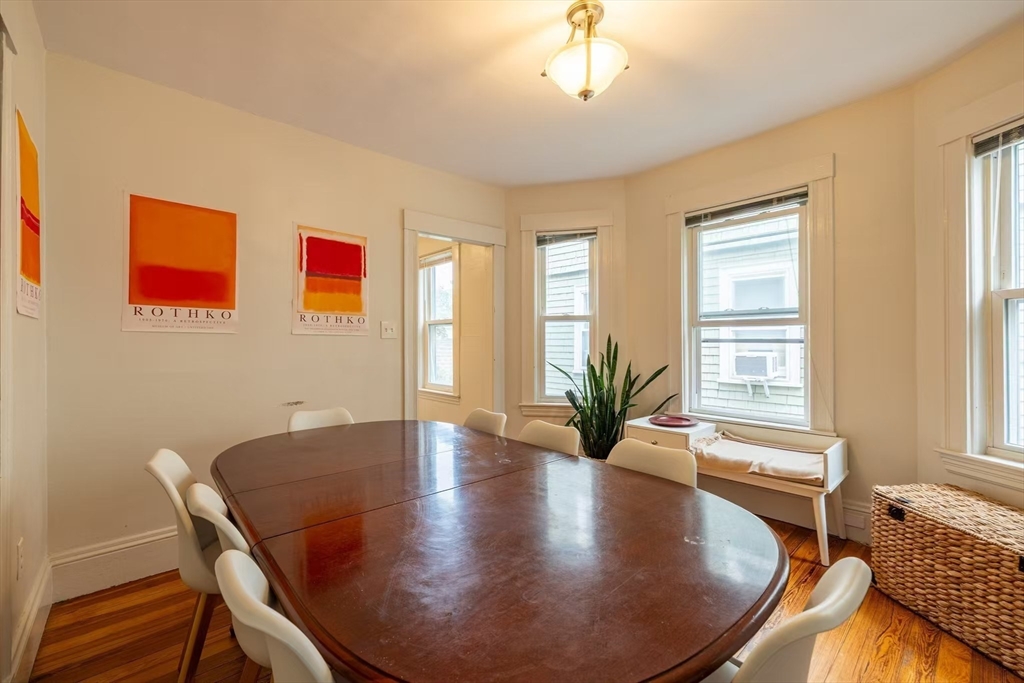 65 Allston Street, Unit 2 Cambridge, MA 02139 - Photo 5 of 11 a view of a dining room with furniture and wooden floor