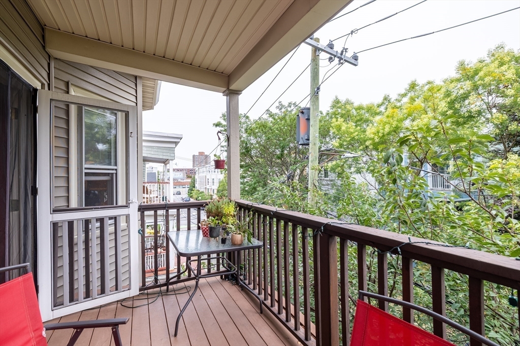 65 Allston Street, Unit 2 Cambridge, MA 02139 - Photo 9 of 11 a view of a balcony with wooden floor