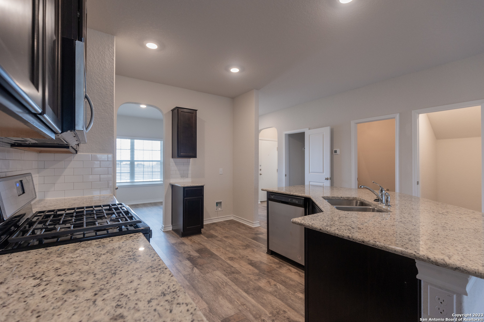 9819 Bratten Rise San Antonio, TX 78254 - Photo 11 of 37 a bathroom with a granite countertop sink a mirror and shower