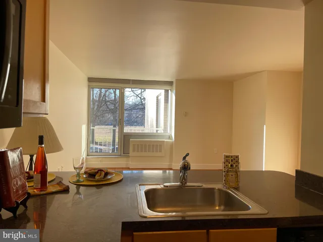 a kitchen with granite countertop a refrigerator and a sink