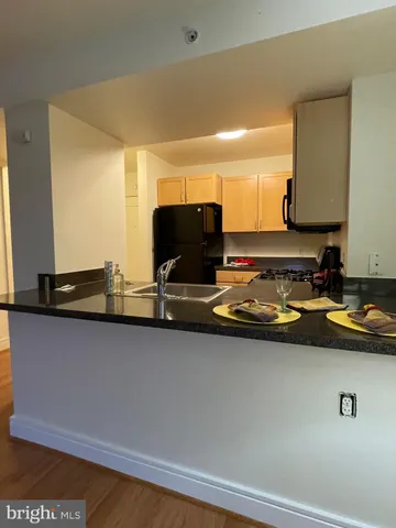 a view of a sink and living room with furniture