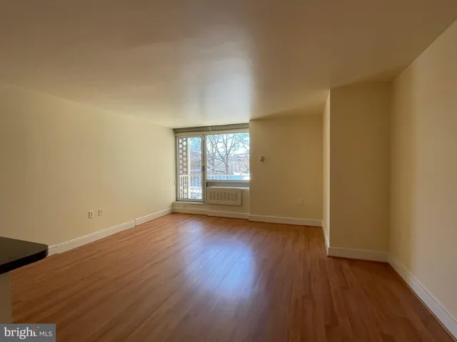 a view of a kitchen with wooden floor and a sink