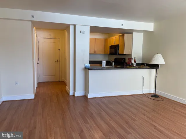 a living room with wooden floor and a wooden floor