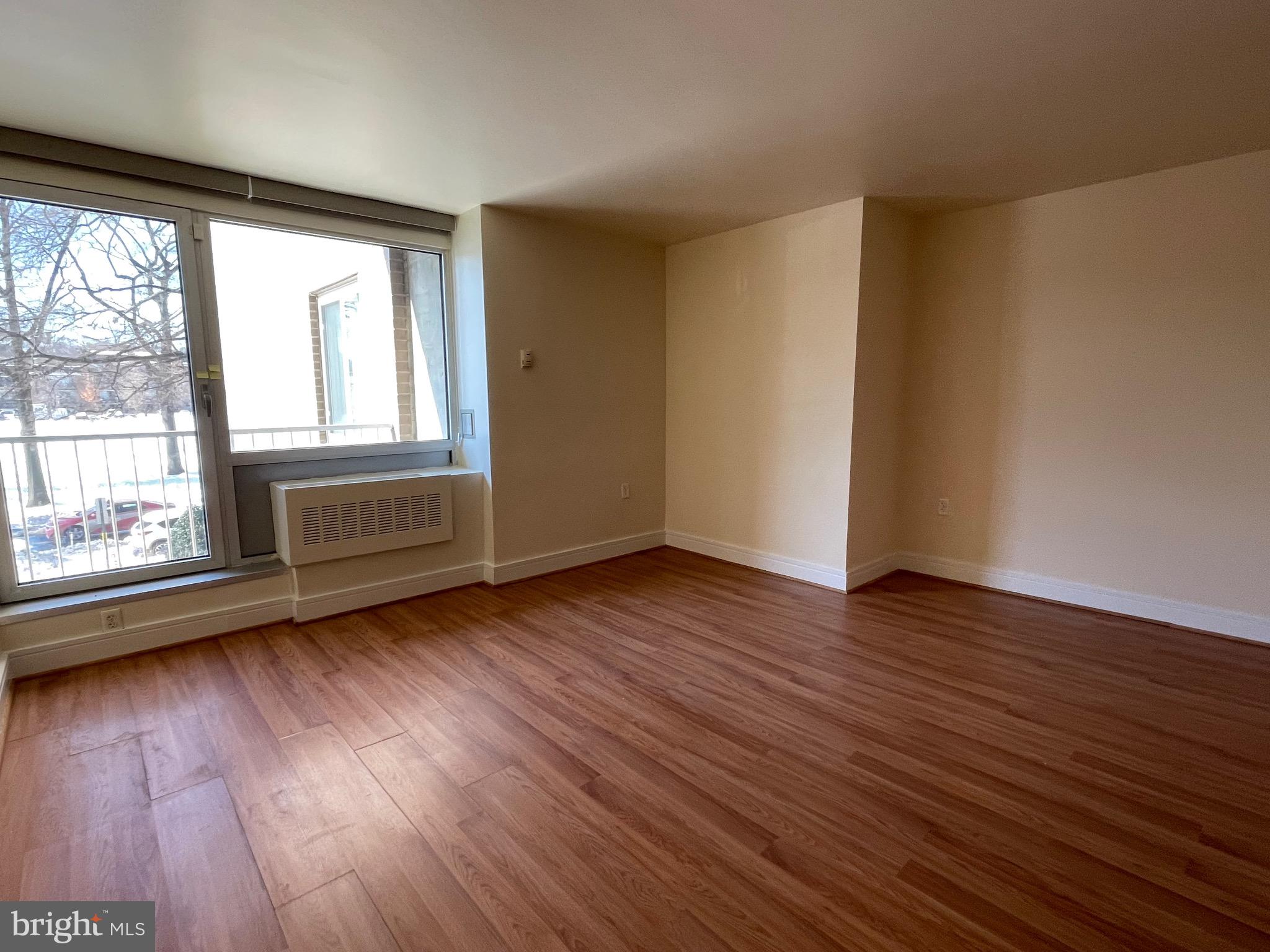 800 4th Street Southwest, Unit N103 Washington, DC 20024 - Photo 22 of 56 an empty room with wooden floor and windows