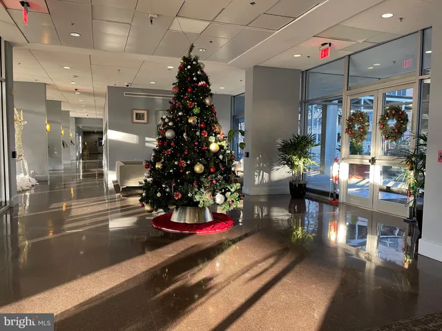 a room with lots of flowers and a chandelier