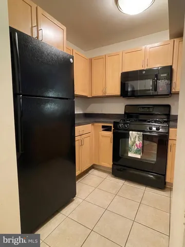 a kitchen with stainless steel appliances a stove a sink and a microwave