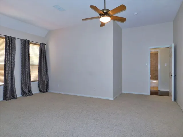 a view of a big room with closet and a chandelier fan