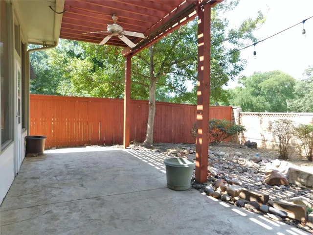 a view of a backyard with wooden fence