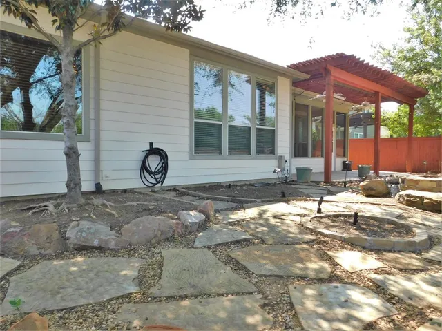 a view of house with backyard and wooden fence