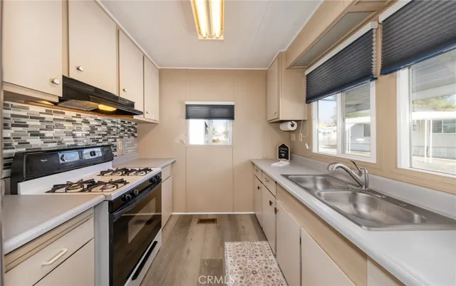 a kitchen with stainless steel appliances granite countertop a stove a refrigerator and a microwave