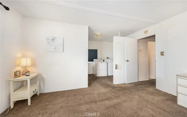 a view of a livingroom with an empty space and a ceiling fan