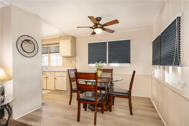 a kitchen with granite countertop a refrigerator a stove a sink and a window