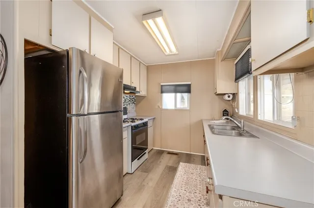 a kitchen that has a sink and a stove