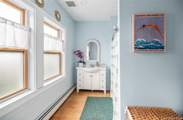 a bedroom with a bed and a view of kitchen