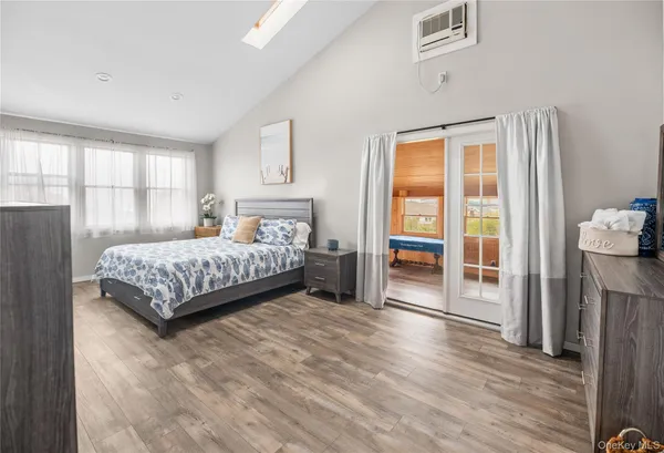 a bedroom with bed and wooden floor