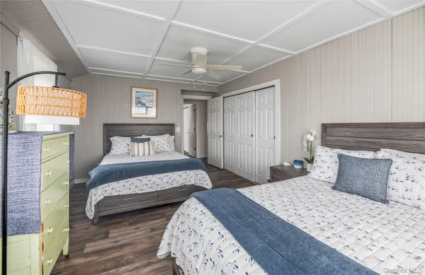 a spacious bedroom with two beds and a window