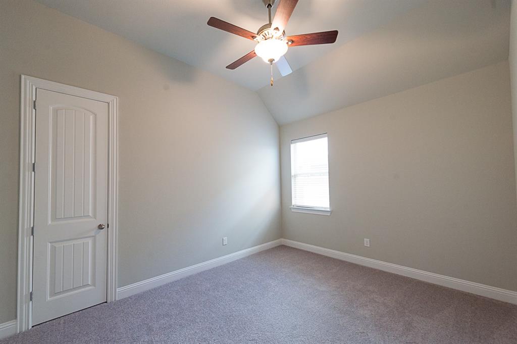 969 Canterbury Lane Forney, TX 75126 - Photo 12 of 24 an empty room with a window and a fan