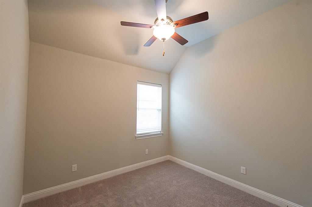 969 Canterbury Lane Forney, TX 75126 - Photo 14 of 24 an empty room with a window and a fan