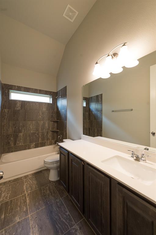 969 Canterbury Lane Forney, TX 75126 - Photo 16 of 24 a bathroom with a sink a toilet and shower