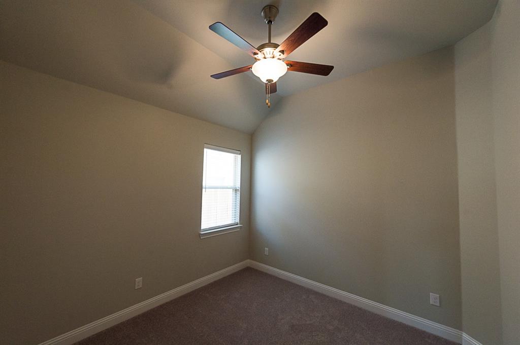 969 Canterbury Lane Forney, TX 75126 - Photo 17 of 24 an empty room with a window and a fan