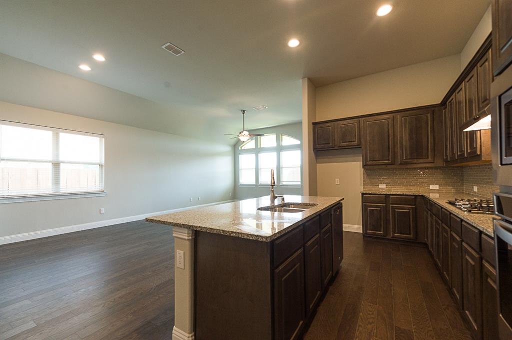 969 Canterbury Lane Forney, TX 75126 - Photo 3 of 24 a kitchen with granite countertop counter space a sink and a window
