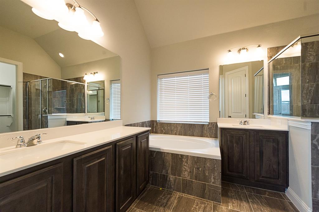 969 Canterbury Lane Forney, TX 75126 - Photo 9 of 24 a bathroom with a bathtub sink double vanity and mirror