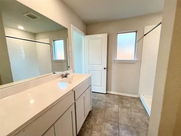 a bathroom with a double vanity sink and mirror