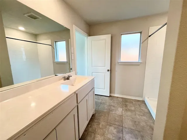 a bathroom with a double vanity sink and mirror