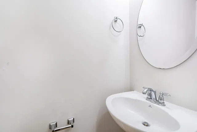 a bathroom with a sink and mirror