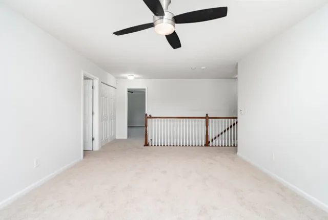 an entryway & ceiling fan in hallway