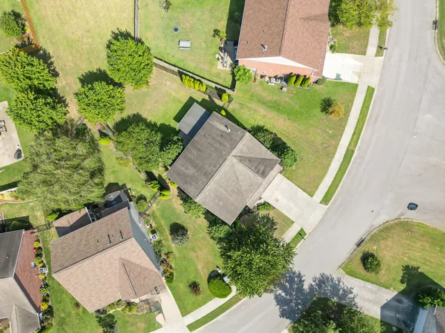 an aerial view of a house with a garden and swimming pool