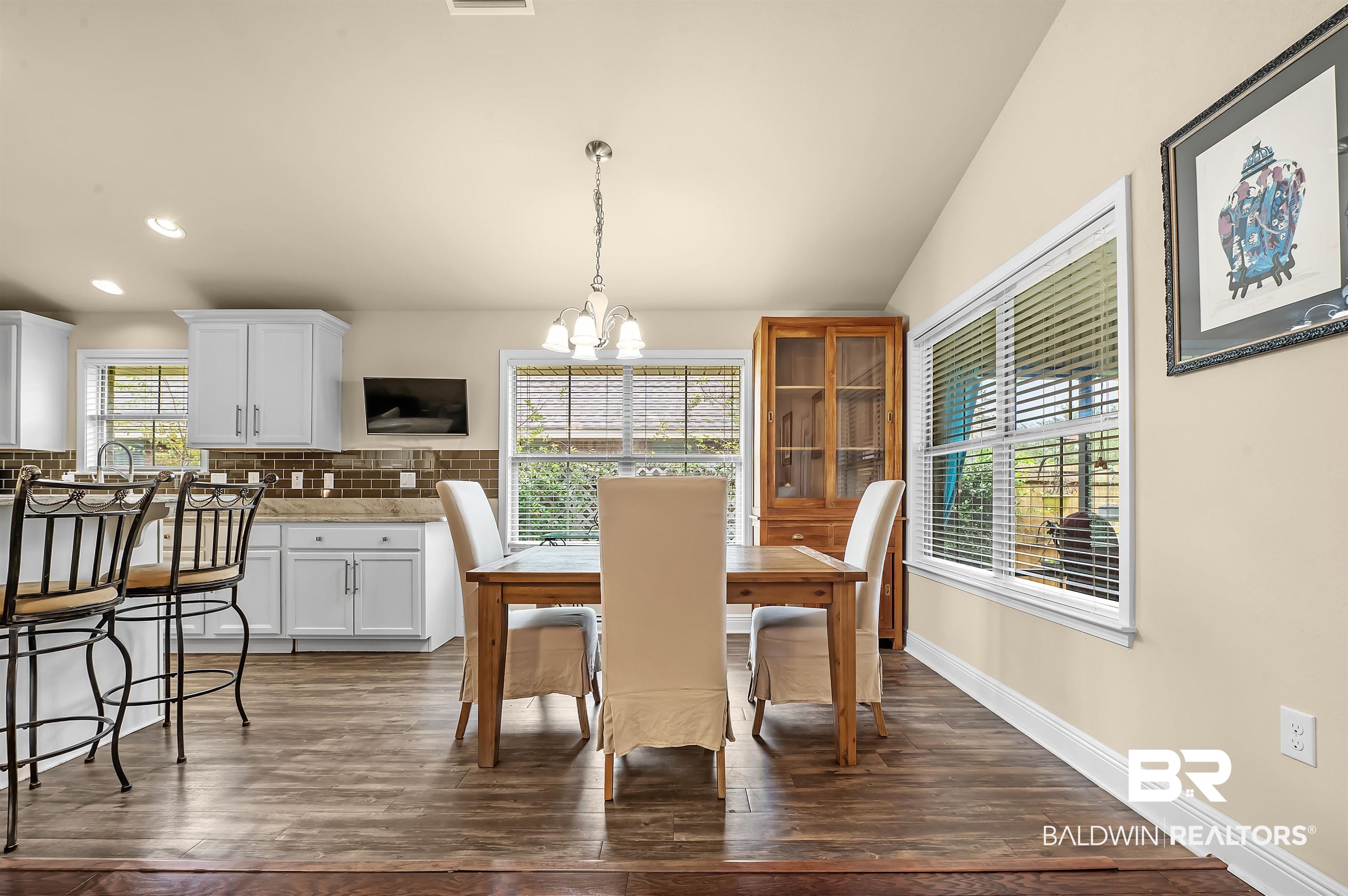 8896 Allay Lane Foley, AL 36535 - Photo 32 of 57 Dining space with lofted ceiling, a chandelier, dark hardwood / wood-style floors, and sink