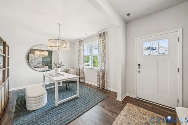 a living room with a couch and chandelier