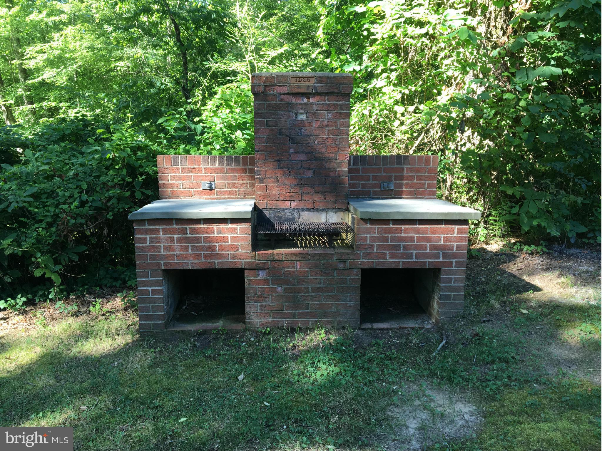 121 Plum Point Road Huntingtown, MD 20639 - Photo 25 of 30 an outdoor sitting area with a fireplace
