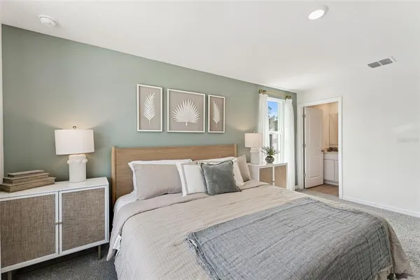 a bedroom with a bed and a lamp