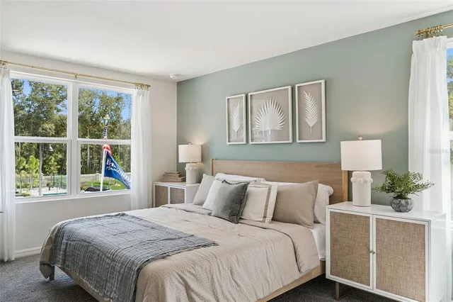 a bedroom with a large bed and a window with outer view