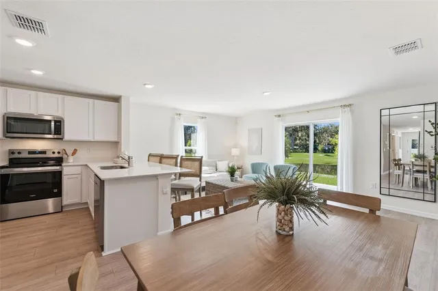 a living room with kitchen island furniture and a wooden floor