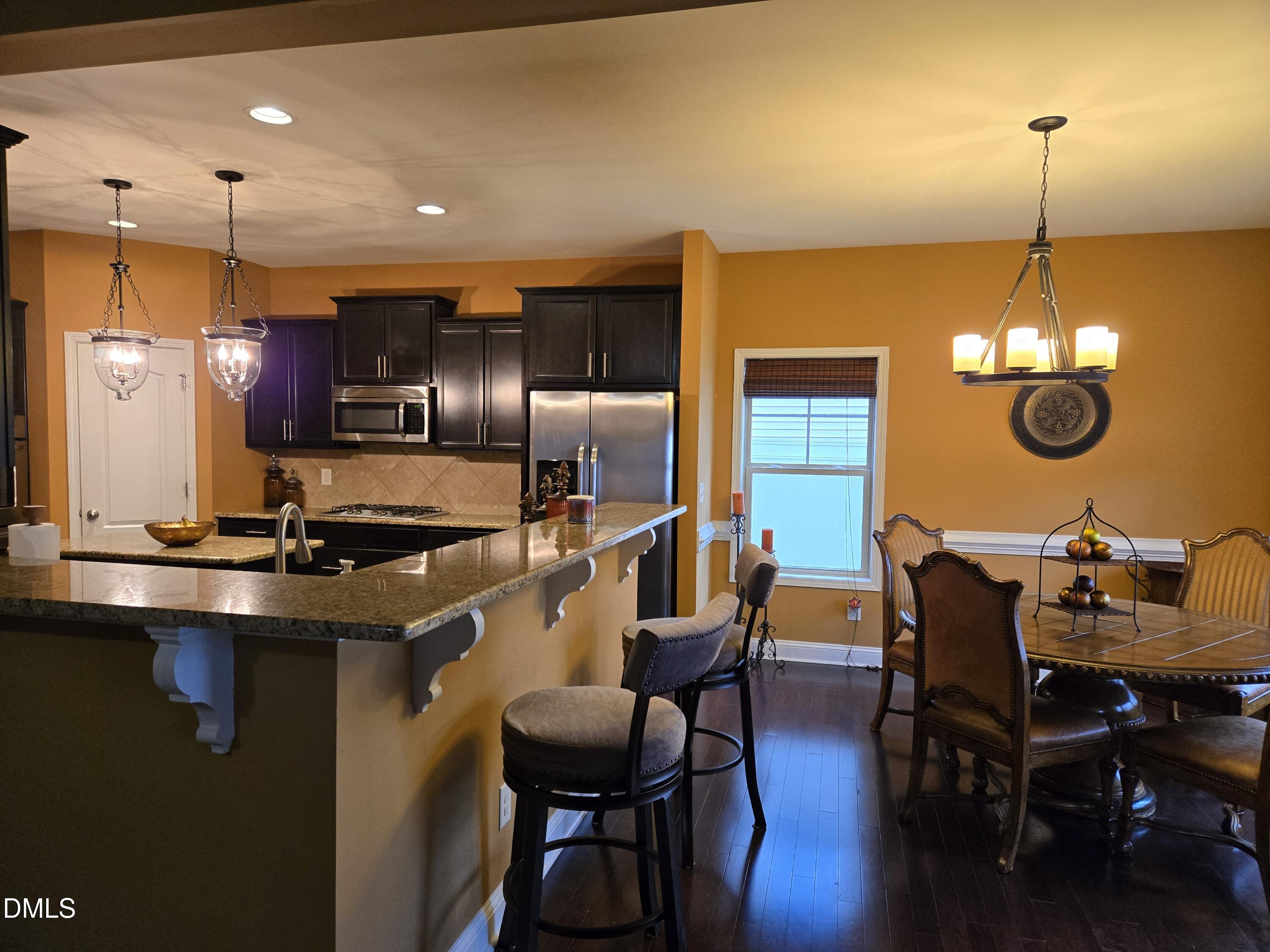 4202 Smithson Court Raleigh, NC 27616 - Photo 11 of 54 a view of a dining room with furniture