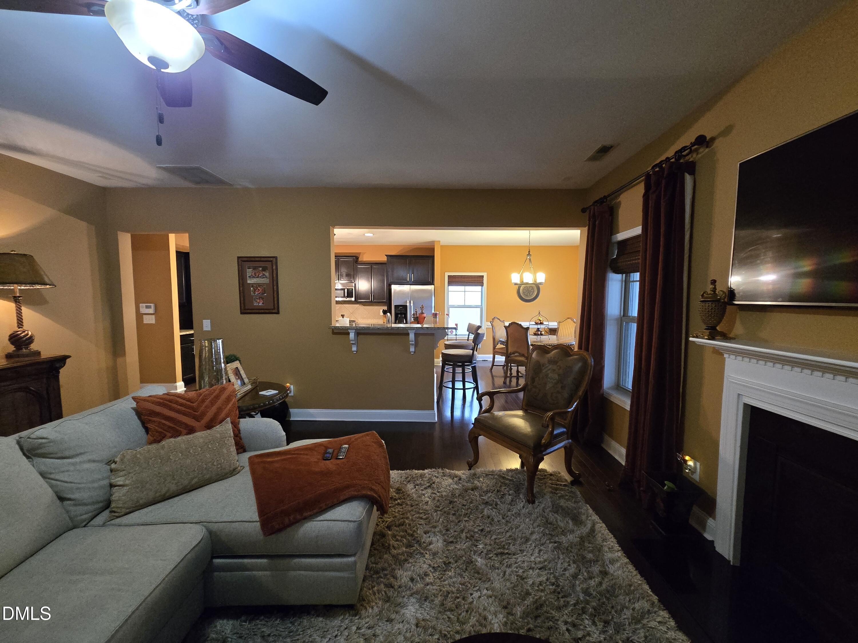 4202 Smithson Court Raleigh, NC 27616 - Photo 12 of 54 a living room with furniture a flat screen tv and a fireplace