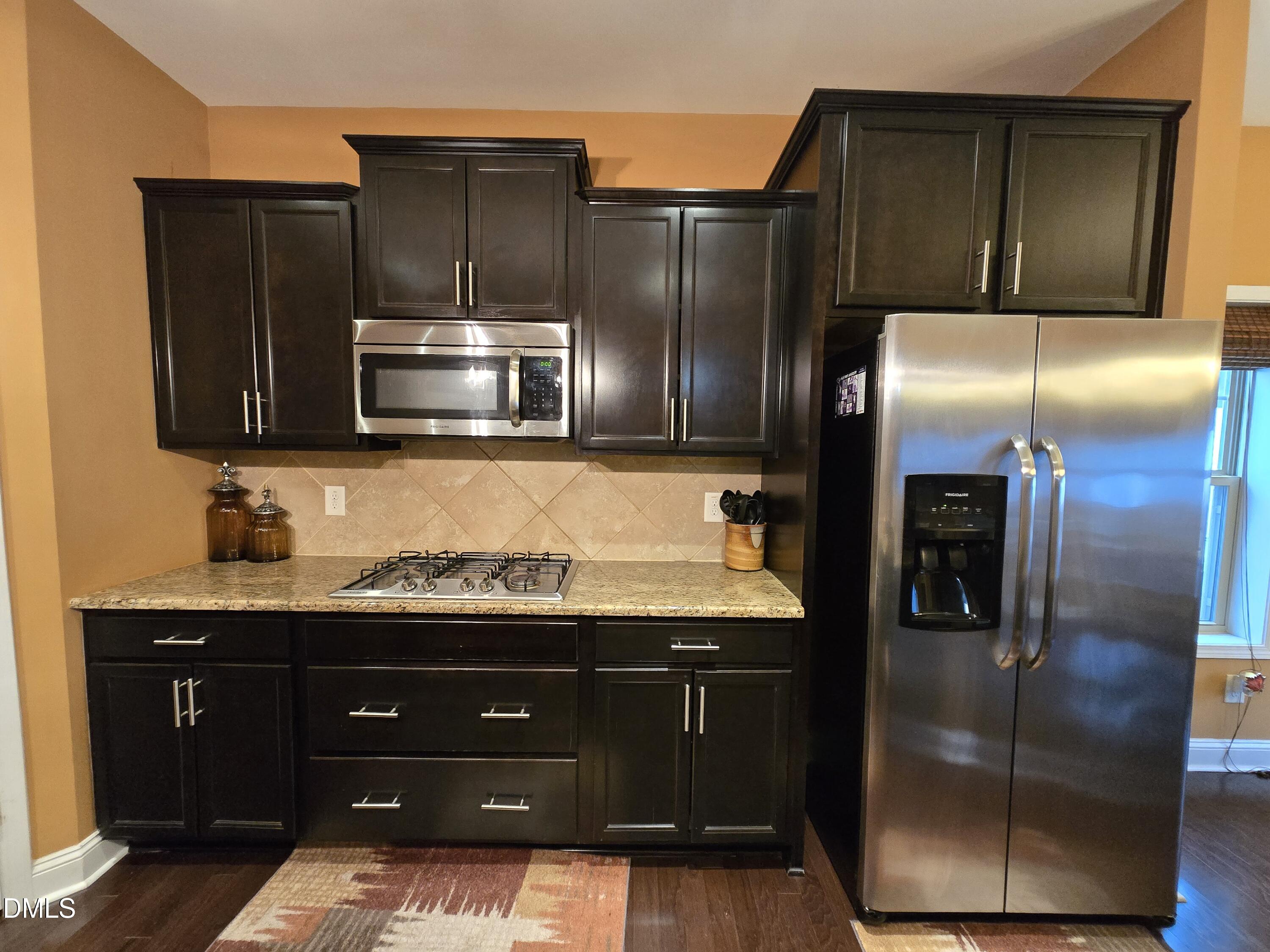 4202 Smithson Court Raleigh, NC 27616 - Photo 16 of 54 a kitchen with stainless steel appliances granite countertop a refrigerator and a cabinets